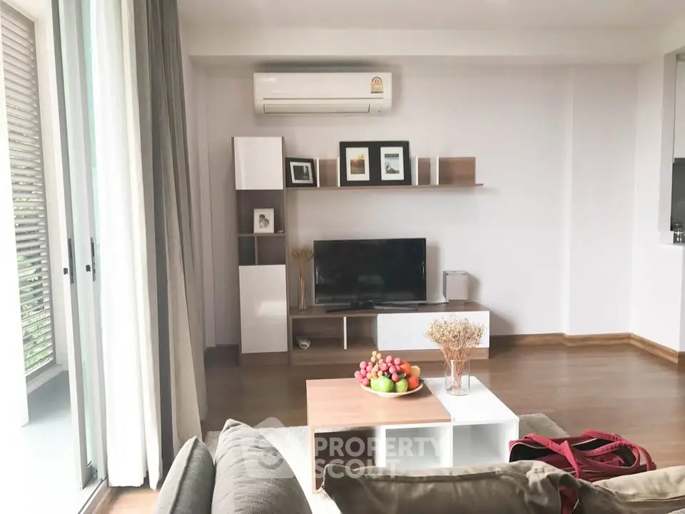 Modern living room with air conditioning, stylish shelving, and cozy seating area.