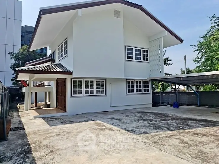 Spacious two-story house with ample parking space and modern design in a serene neighborhood.