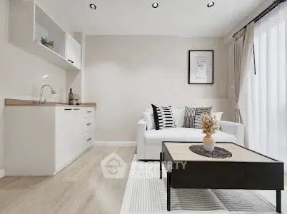 Modern living room with stylish decor and open kitchen layout, featuring a cozy sofa and elegant coffee table.