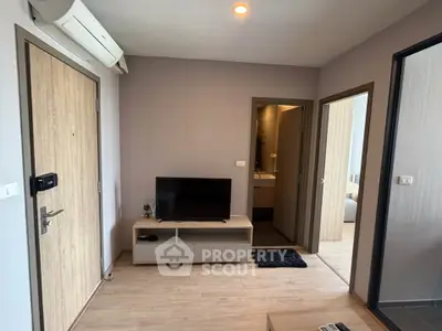 Modern living room with TV and air conditioning in a cozy apartment.