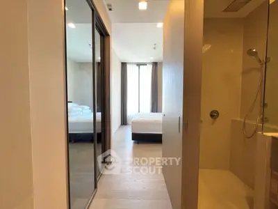 Modern bedroom with ensuite bathroom and large mirror closet