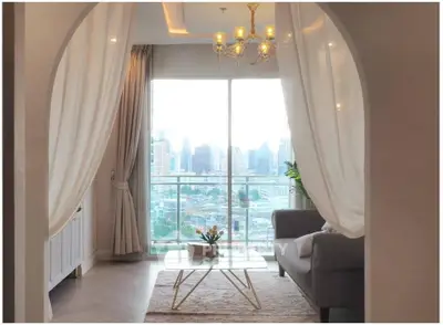 Elegant living room with city view, modern decor, and stylish chandelier.