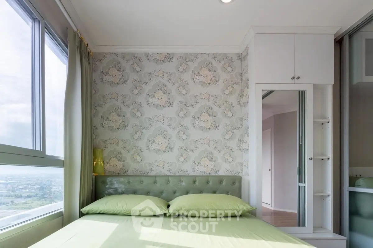 Charming bedroom with floral wallpaper and panoramic window view