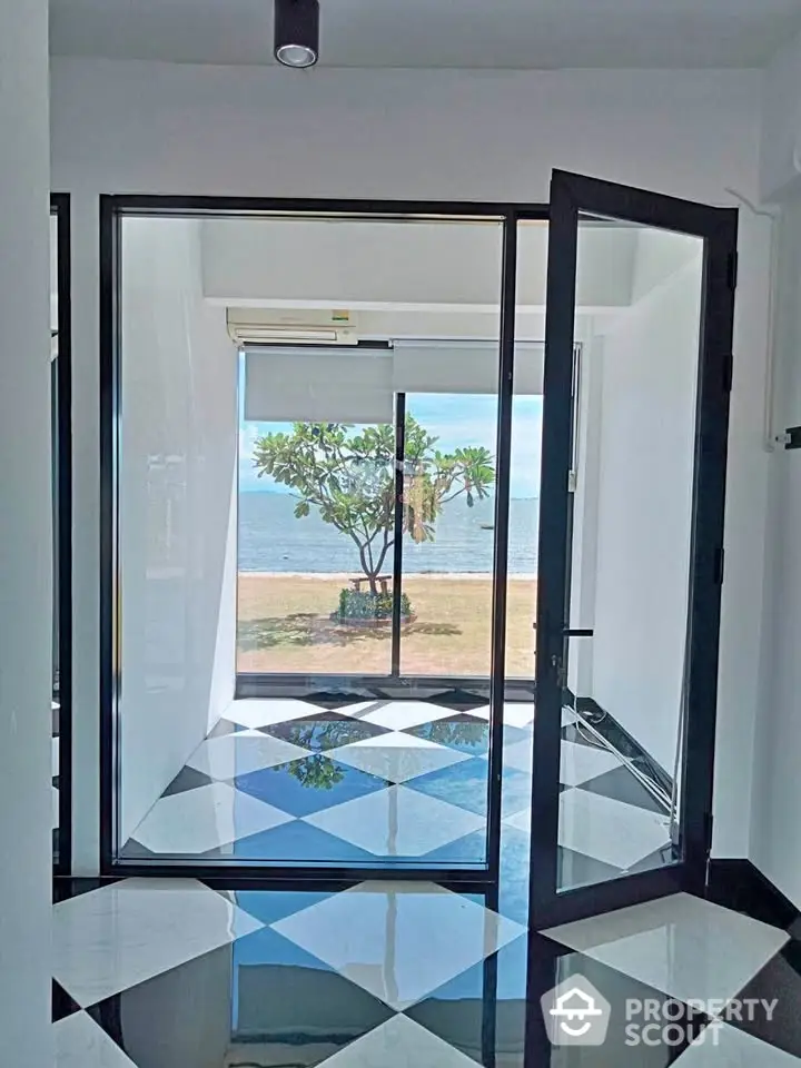 Stunning beachfront room with glass doors and checkered floor tiles