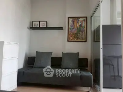 Cozy living room with modern sofa and elegant wall art, perfect for relaxation.