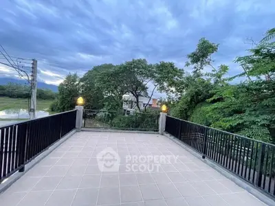 Spacious balcony with scenic view of lush greenery and serene surroundings.