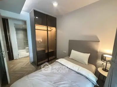 Modern bedroom with ensuite bathroom and sleek wardrobe design.