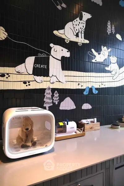 Charming kitchen with playful animal-themed wall tiles and modern appliances.