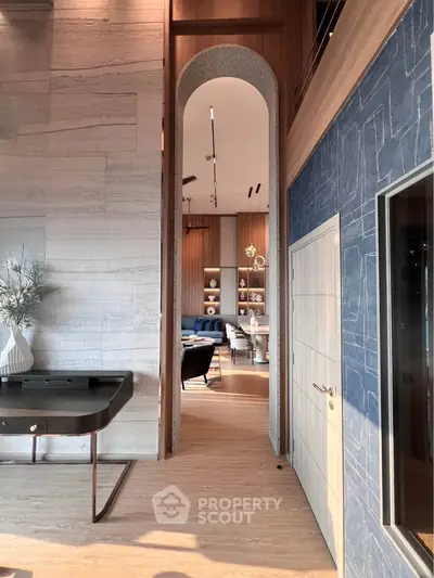 Luxurious modern interior with high ceilings and elegant decor, featuring a stylish living area and dining space.