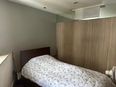 Cozy bedroom with modern wooden wardrobe and stylish decor