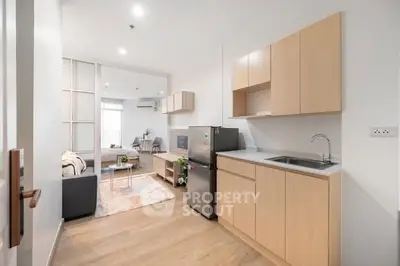 Modern open-plan kitchen and living area with sleek design and natural light.