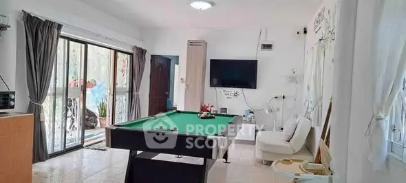 Spacious living room with pool table and modern decor
