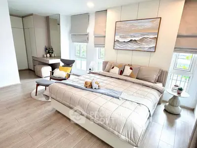 Luxurious bedroom with elegant decor and large windows offering natural light.