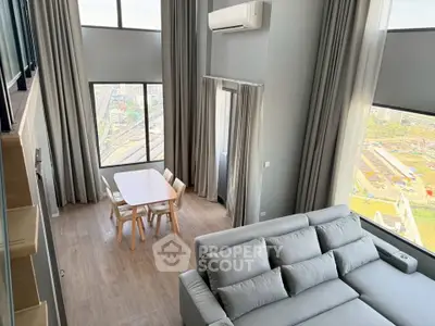 Spacious modern living room with large windows and stunning city view