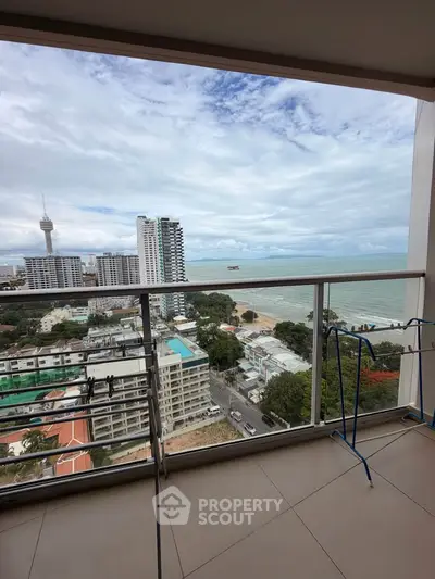 Stunning high-rise balcony view overlooking cityscape and ocean, perfect for urban living with a serene touch.