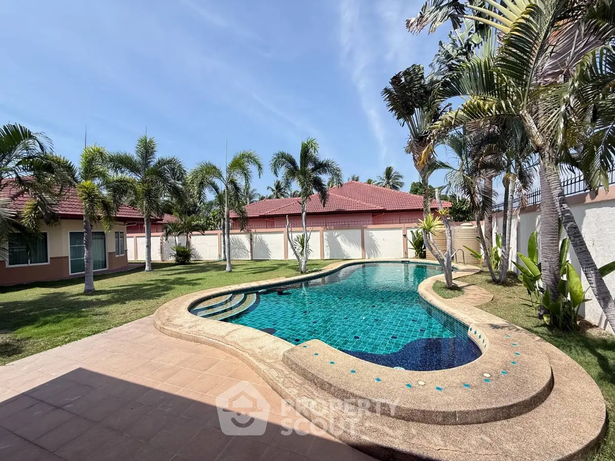 Luxurious private villa with stunning pool and lush garden, perfect for relaxation and entertainment.