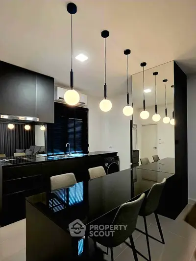 Modern kitchen with sleek black cabinetry and stylish pendant lighting