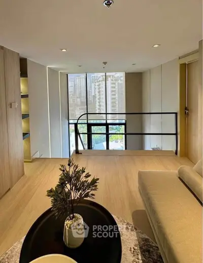 Modern living room with city view, elegant decor, and natural light.
