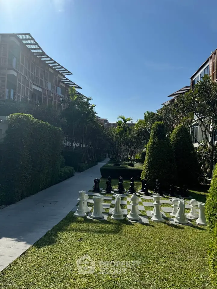 Luxurious garden area with giant chess set in upscale residential complex