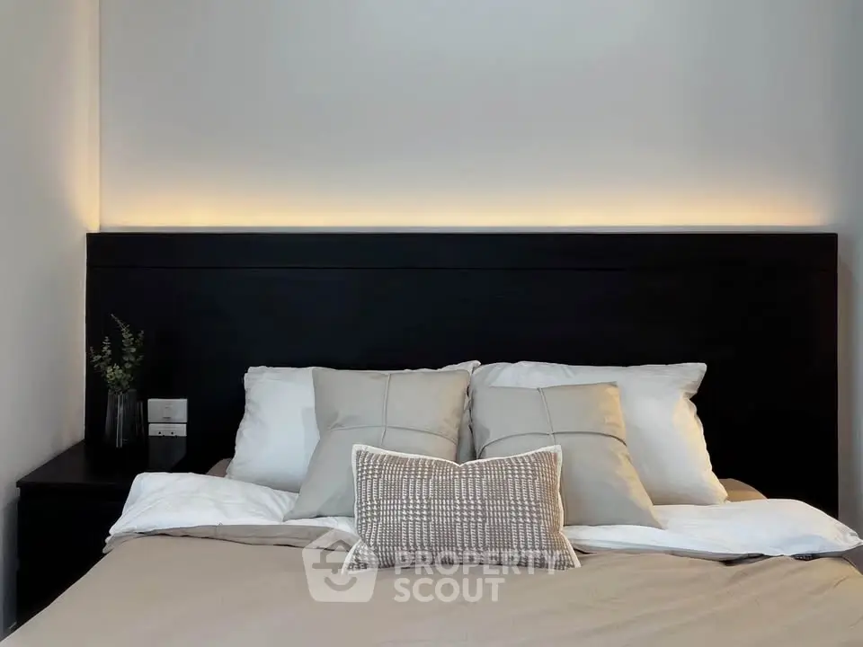 Cozy bedroom with modern headboard and soft lighting