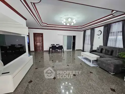 Spacious living room with modern decor and elegant ceiling design