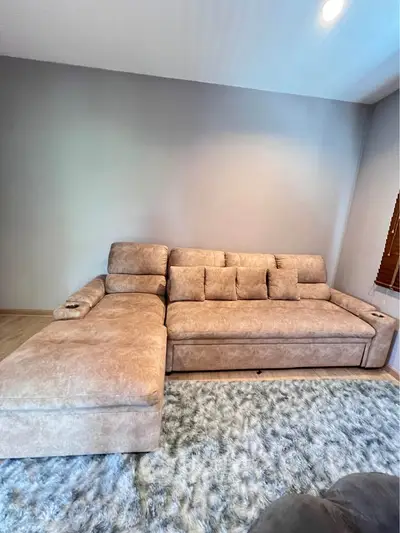 Spacious living room with plush sectional sofa and cozy carpet, perfect for relaxation and entertainment.