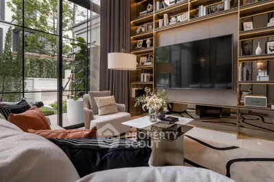 Luxurious living room with modern decor and large TV, featuring floor-to-ceiling windows and elegant shelving.