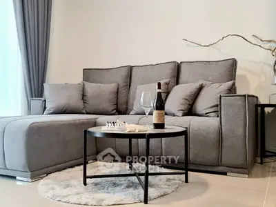 Modern living room with stylish gray sofa and chic decor