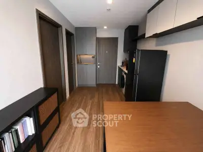 Modern apartment interior with sleek kitchen and wooden flooring