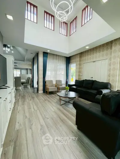 Spacious living room with high ceiling and modern decor in a luxury home
