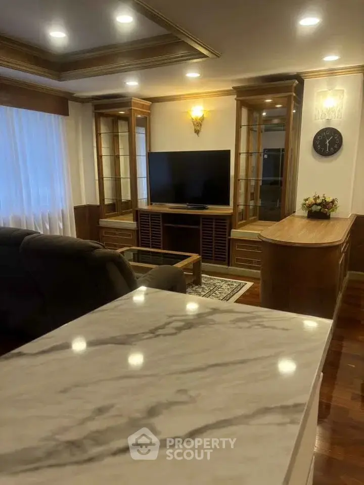 Luxurious living room with elegant wooden cabinetry and modern lighting