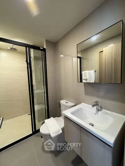 Modern bathroom with sleek fixtures and spacious shower area