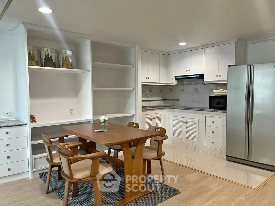 Charming kitchen with modern appliances and cozy dining area in a stylish open layout.