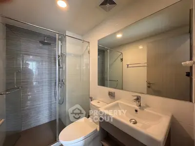 Modern bathroom with glass shower and sleek fixtures