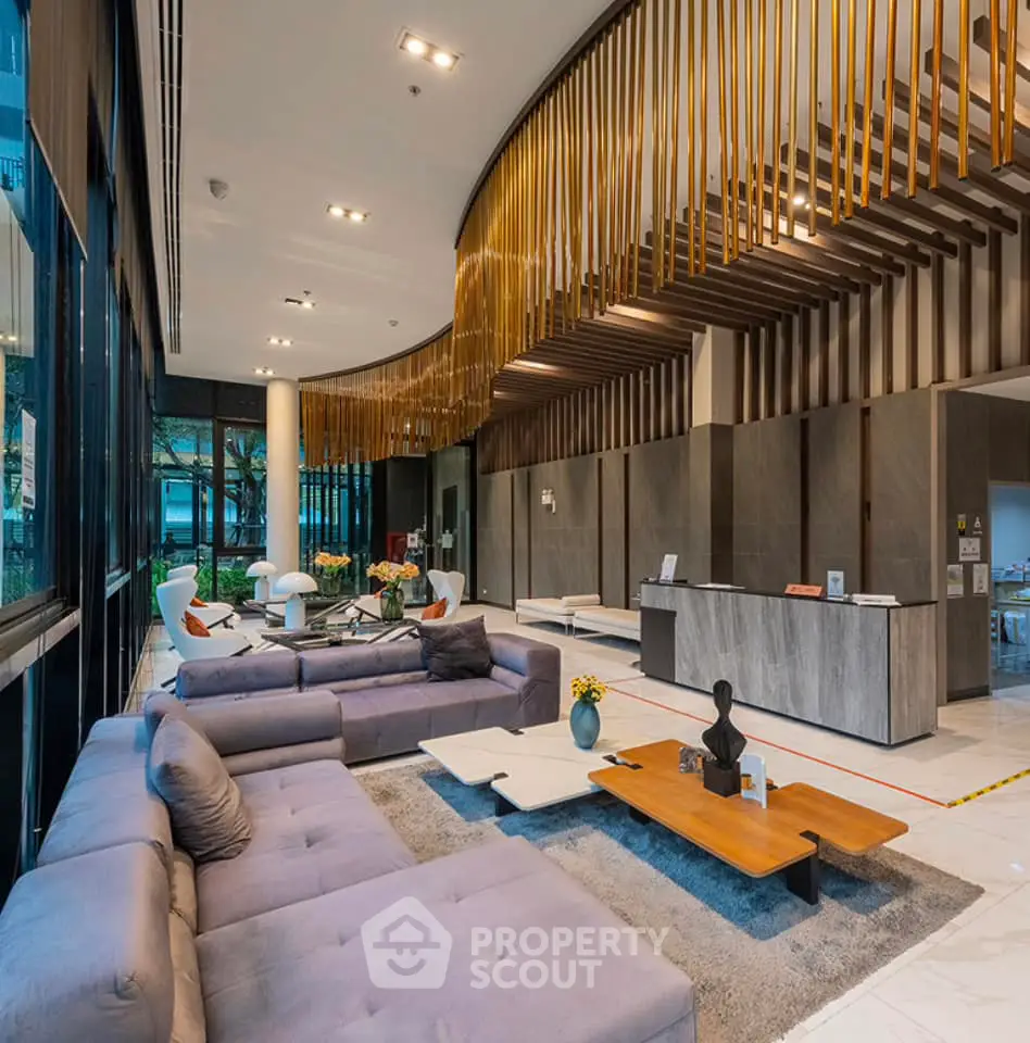 Luxurious modern lobby with elegant seating and stylish decor in a high-end residential building.