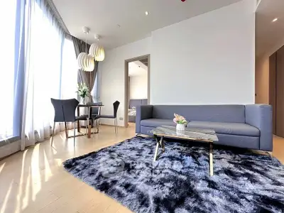 Modern living room with stylish furniture and large windows in a bright apartment.