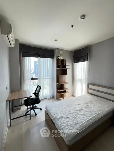Modern bedroom with city view, featuring a study desk and minimalist decor.