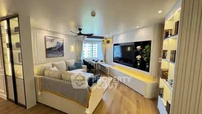 Luxurious living room with modern decor and large windows offering stunning city views.