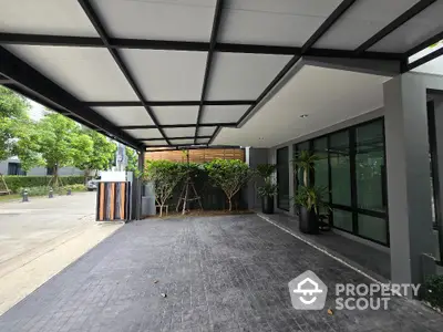 Modern home entrance with sleek design and spacious driveway