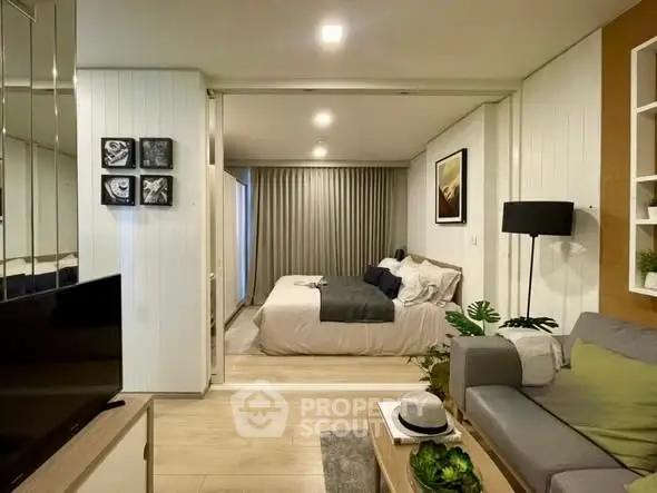 Modern studio apartment with cozy living area and stylish bedroom, featuring elegant decor and warm lighting.