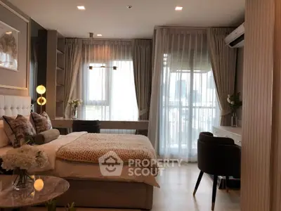 Luxurious bedroom with elegant decor and large windows offering natural light.