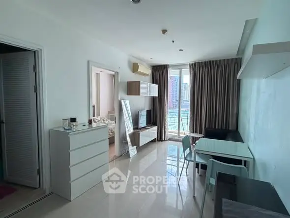 Modern apartment interior with open living area and city view.