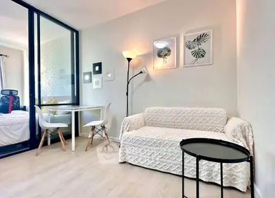 Chic modern living room with cozy sofa and stylish decor in a bright apartment.