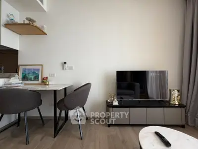 Modern living room with sleek furniture and flat-screen TV, perfect for cozy relaxation.