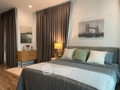 Luxurious bedroom with elegant decor and large windows in modern apartment.