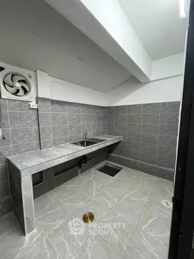 Modern kitchen with sleek gray tiles and minimalist design