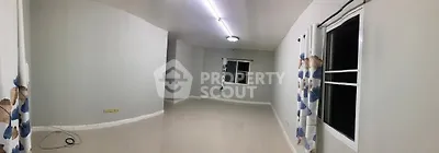 Spacious empty room with tiled flooring and large windows, ideal for customization.