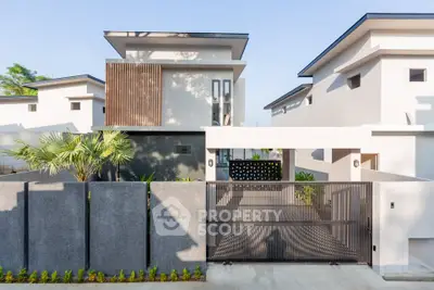 Modern minimalist house exterior with sleek design and gated entrance, showcasing contemporary architecture.