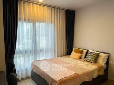 Cozy bedroom with elegant curtains and stylish bedding in modern apartment