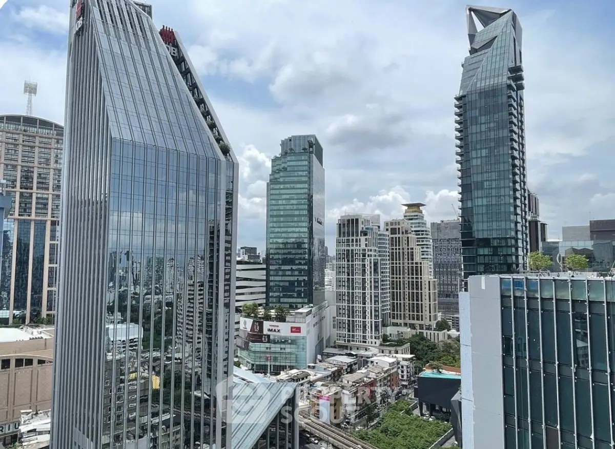 Stunning cityscape view of modern skyscrapers with unique architectural designs under a clear blue sky.